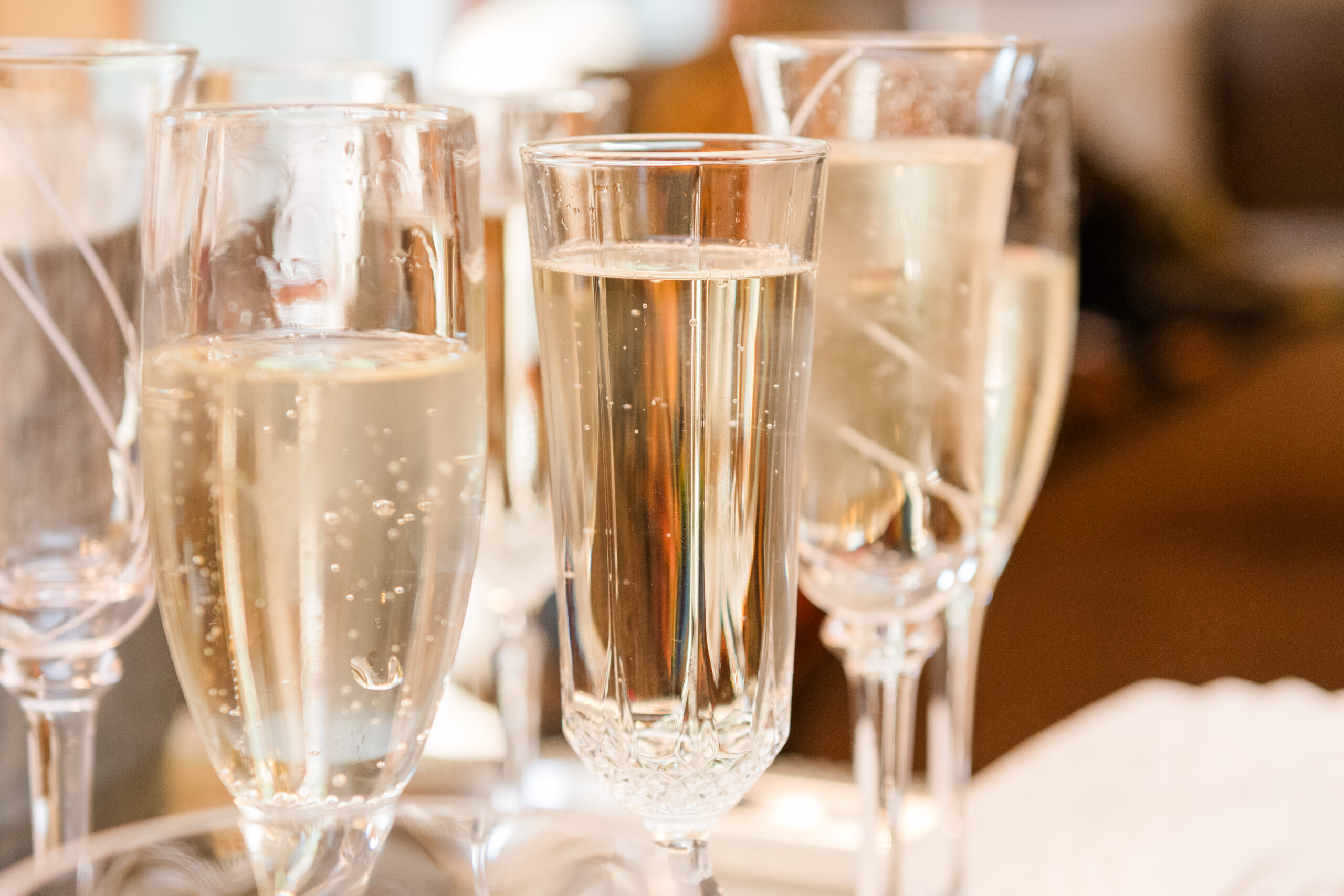 Several champagne glasses filled with bubbling champagne, ready for Dr. Emma's bridal shower